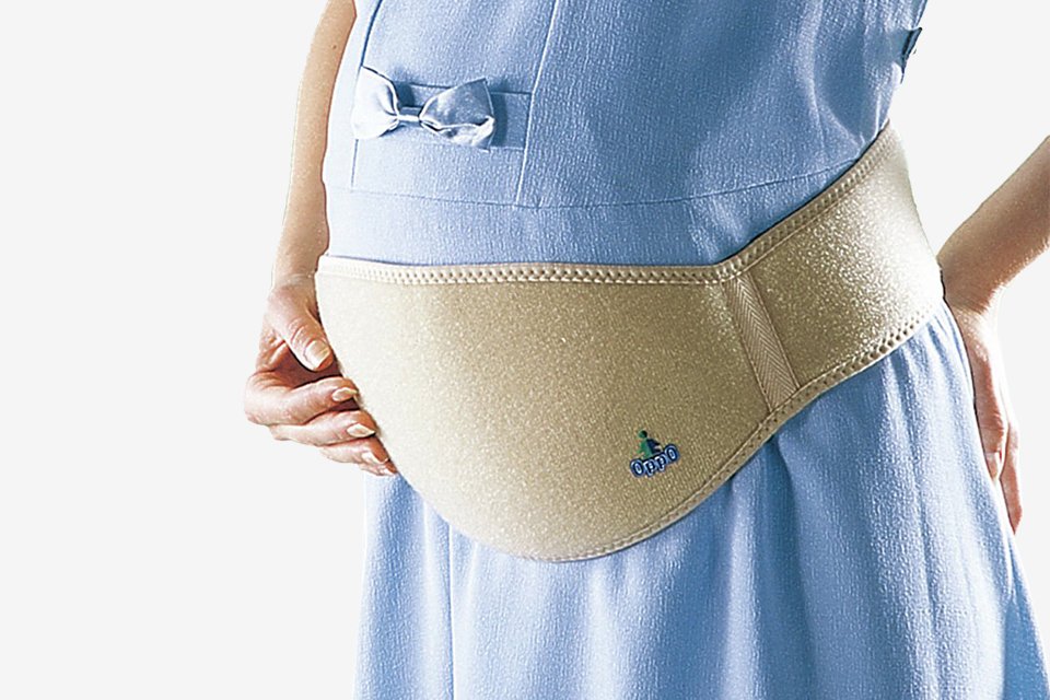 A pregnant woman wearing an OppO Medical maternity stress reliever belt.